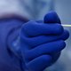 A health worker collects a nasal swab from a man during a random testing for COVID-19 in Itagui, Columbia.